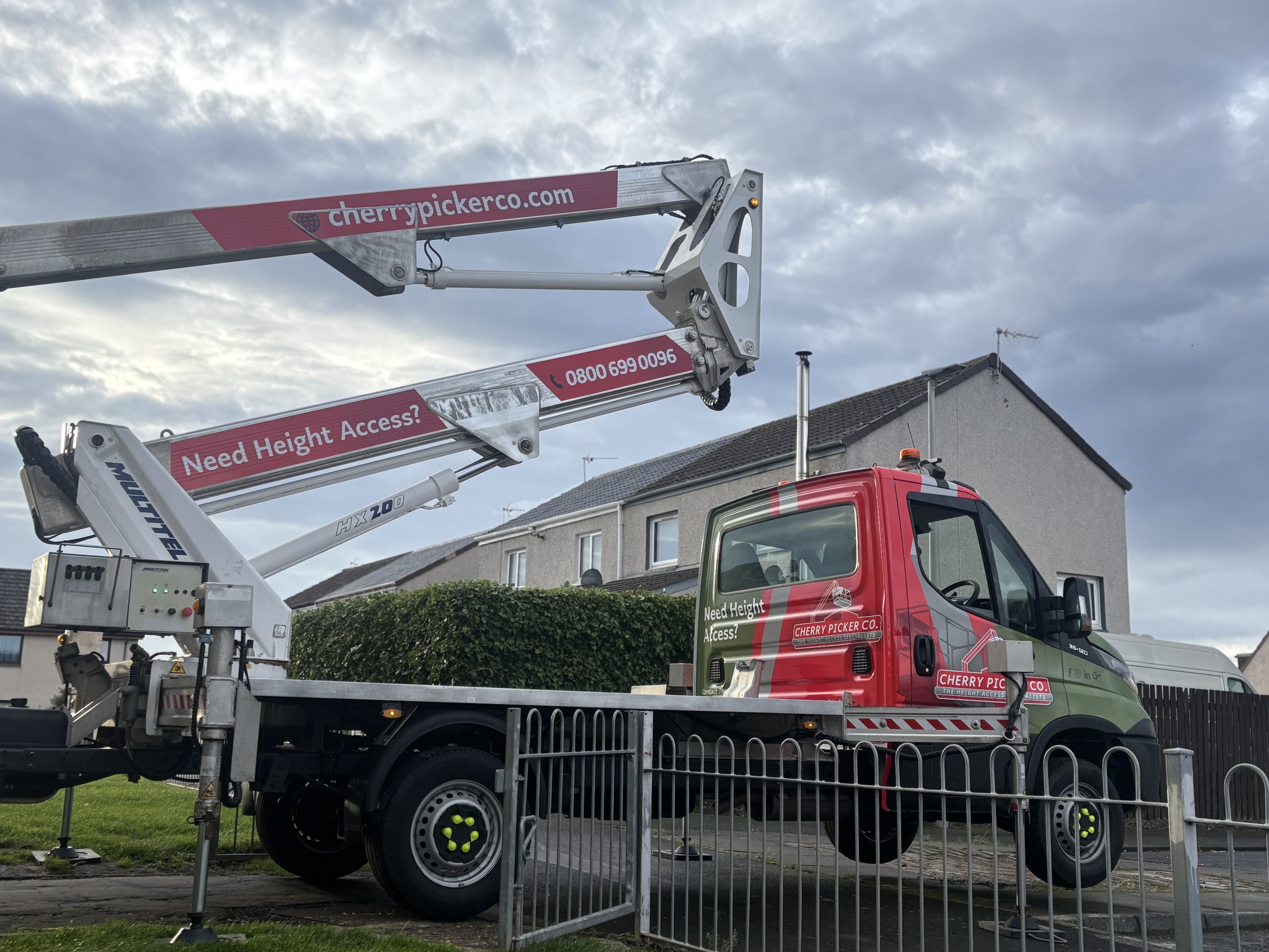 Cherry picker at height on site